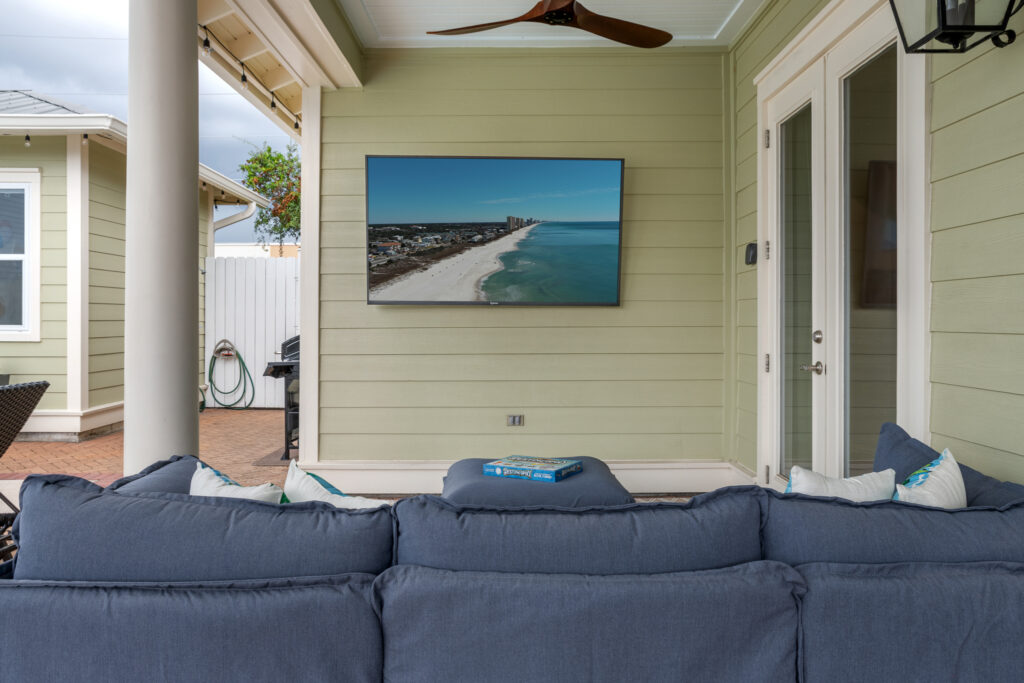 Covered patio with outdoor TV and sofa