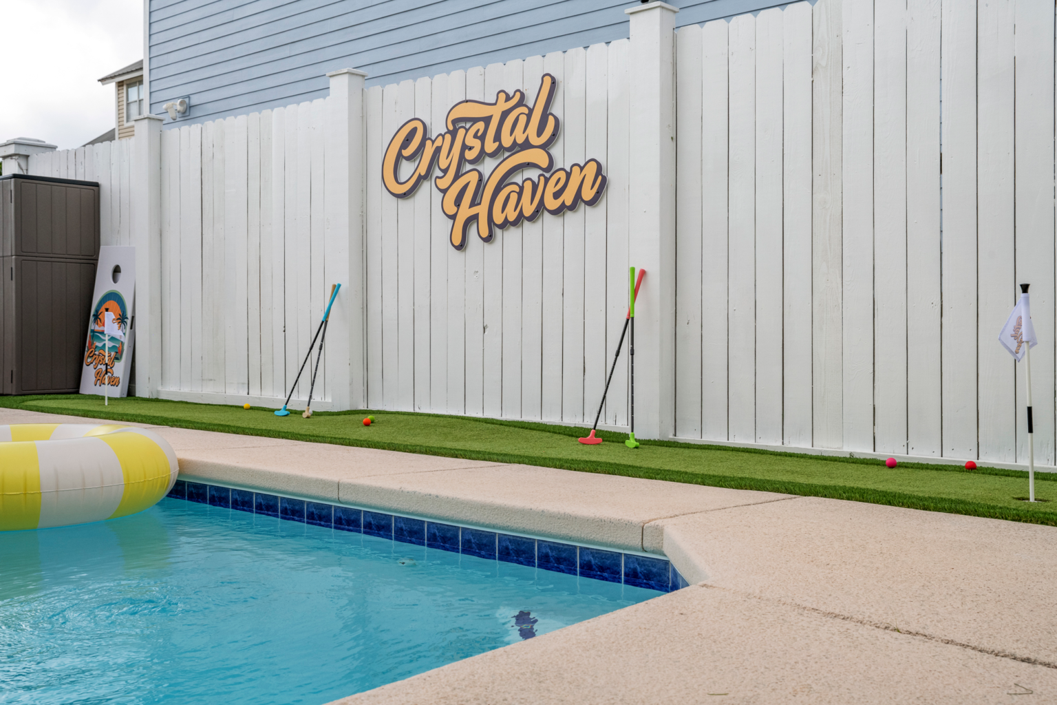 The backyard, pickleball court, and putting green